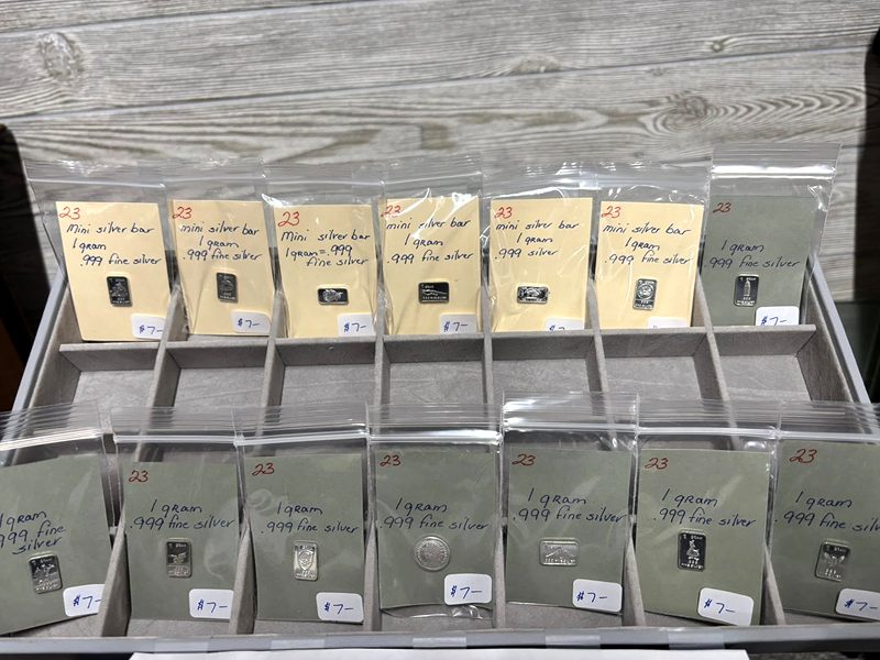 Rows of 1 gram silver bars in labeled sleeves