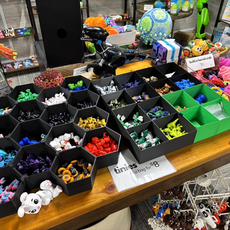 Hexagon bins full of small, colorful 3D-printed figures