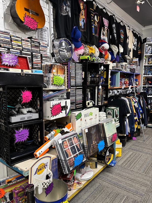 An aisle of CDs, video games, hats and T-shirts