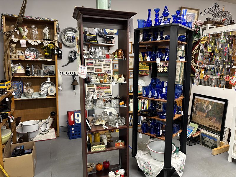 Shelves of cobalt blue glass, clocks and china