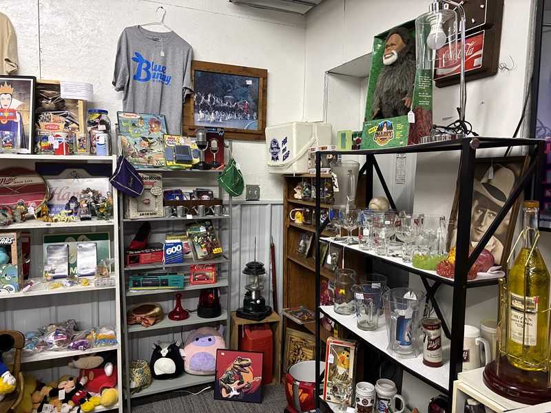 Shelves of glassware, toys, plush animals and mugs