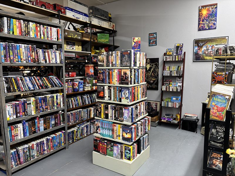 Shelves packed with VHS tapes and DVDs