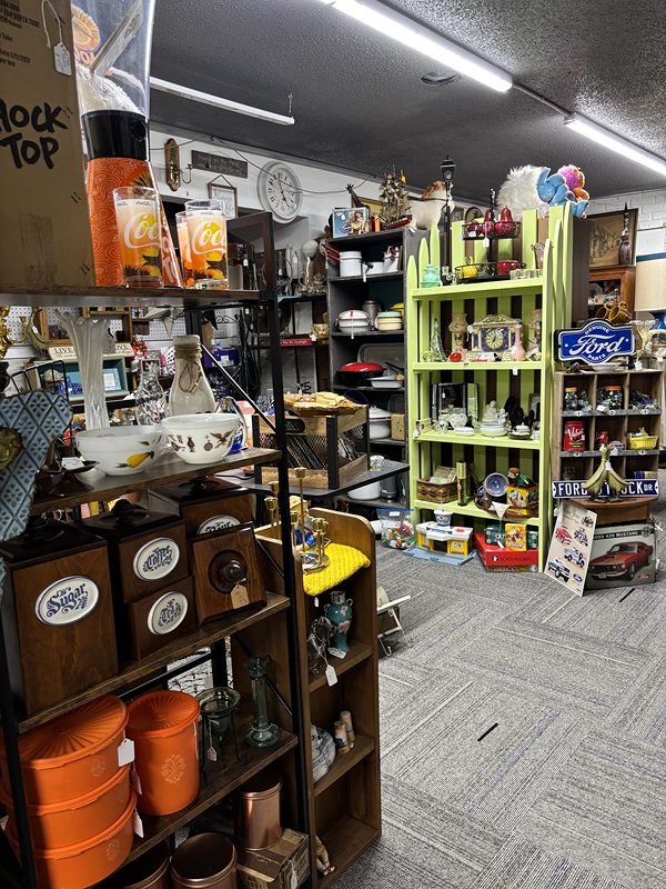 An aisle of kitchenware shelves, a lime-green shelf and a Ford sign