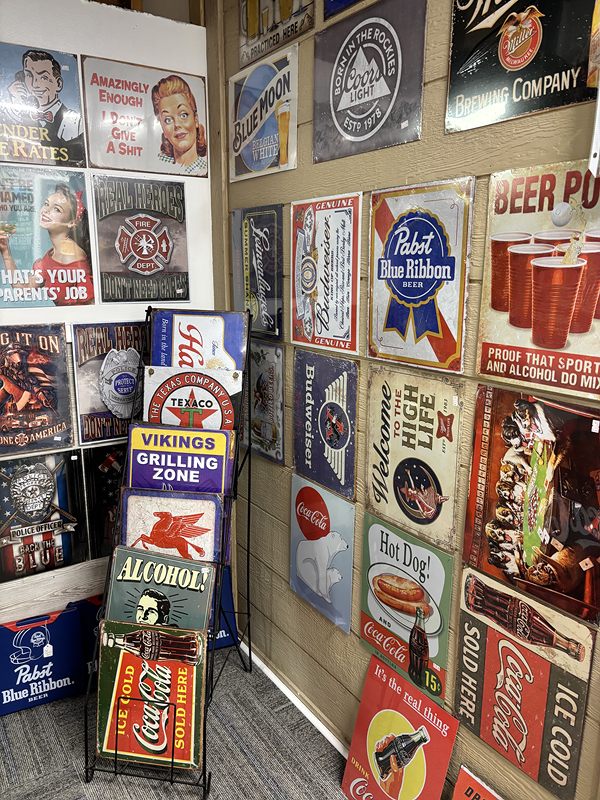 Walls covered in vintage-style metal beer and soda signs