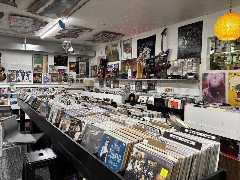 Rows of vinyl records beneath Beatles and band posters
