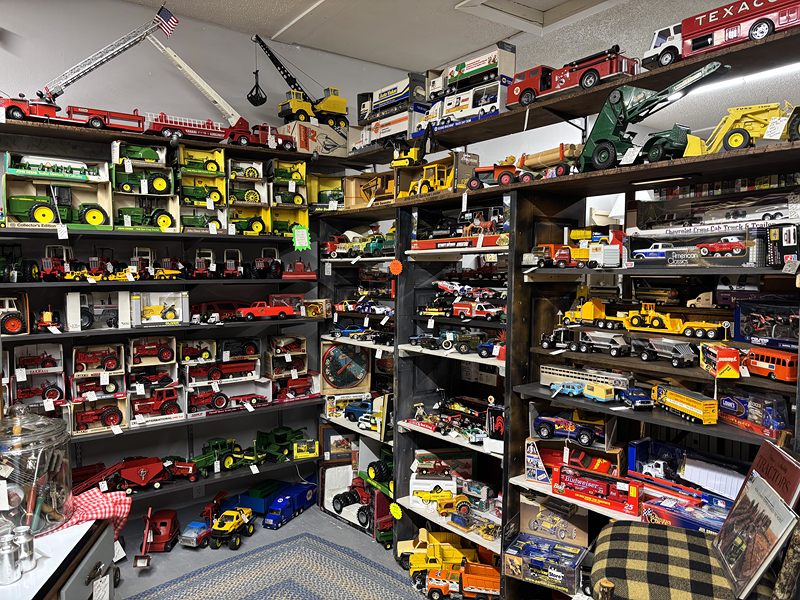 Floor-to-ceiling shelves of die-cast farm toys, tractors and trucks